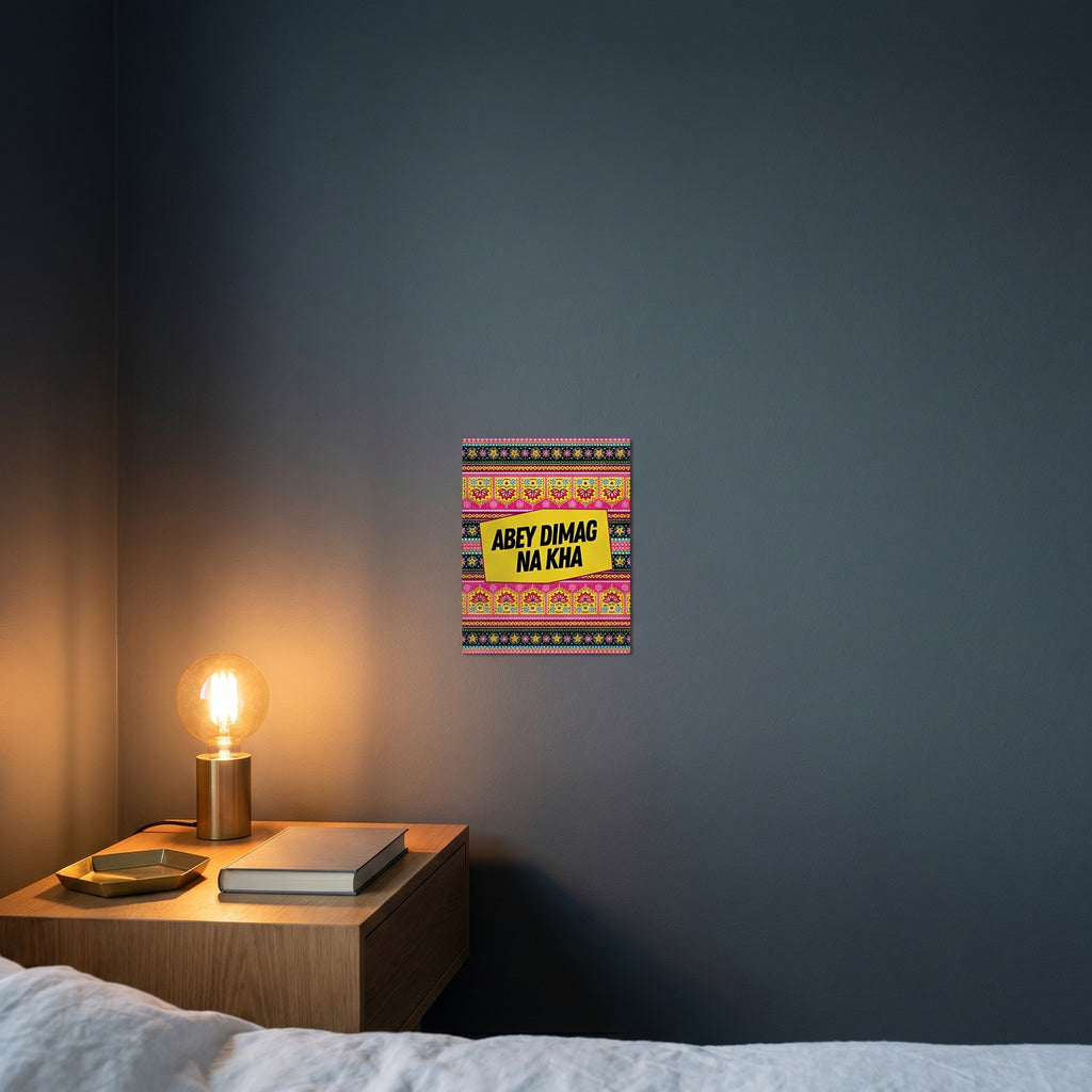 Contemporary bedroom nightstand setup featuring the colorful Abey Dimag Na Kha framed poster catching warm ambient lamp light.
