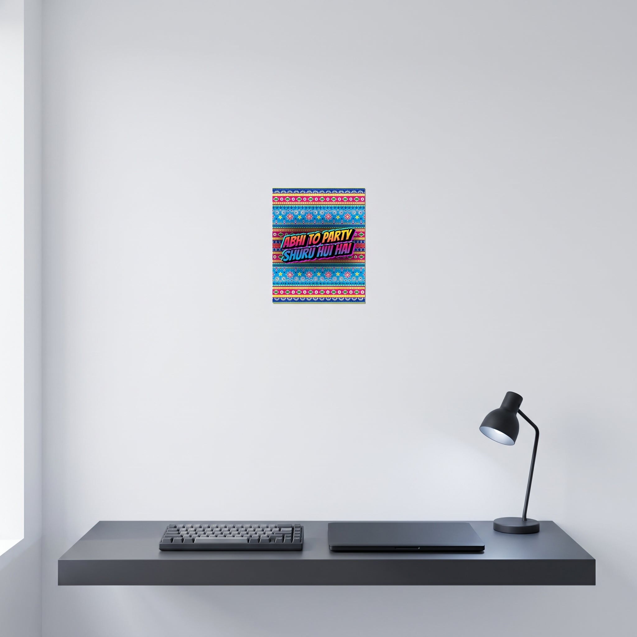 Funny Desi anthem aluminum wall art displayed on a crisp white wall behind a minimalist home office desk workspace setup.
