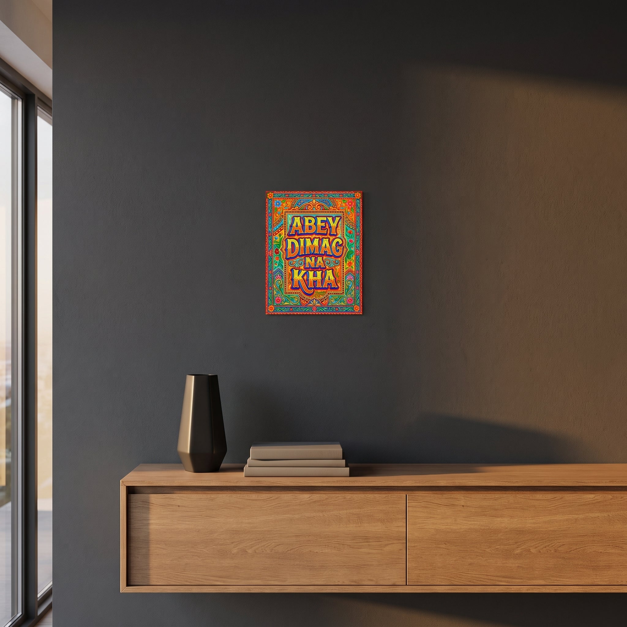 Modern style funny Desi phrase art print displayed on a dark charcoal grey accent wall over a sleek wooden console floating cabinet.
