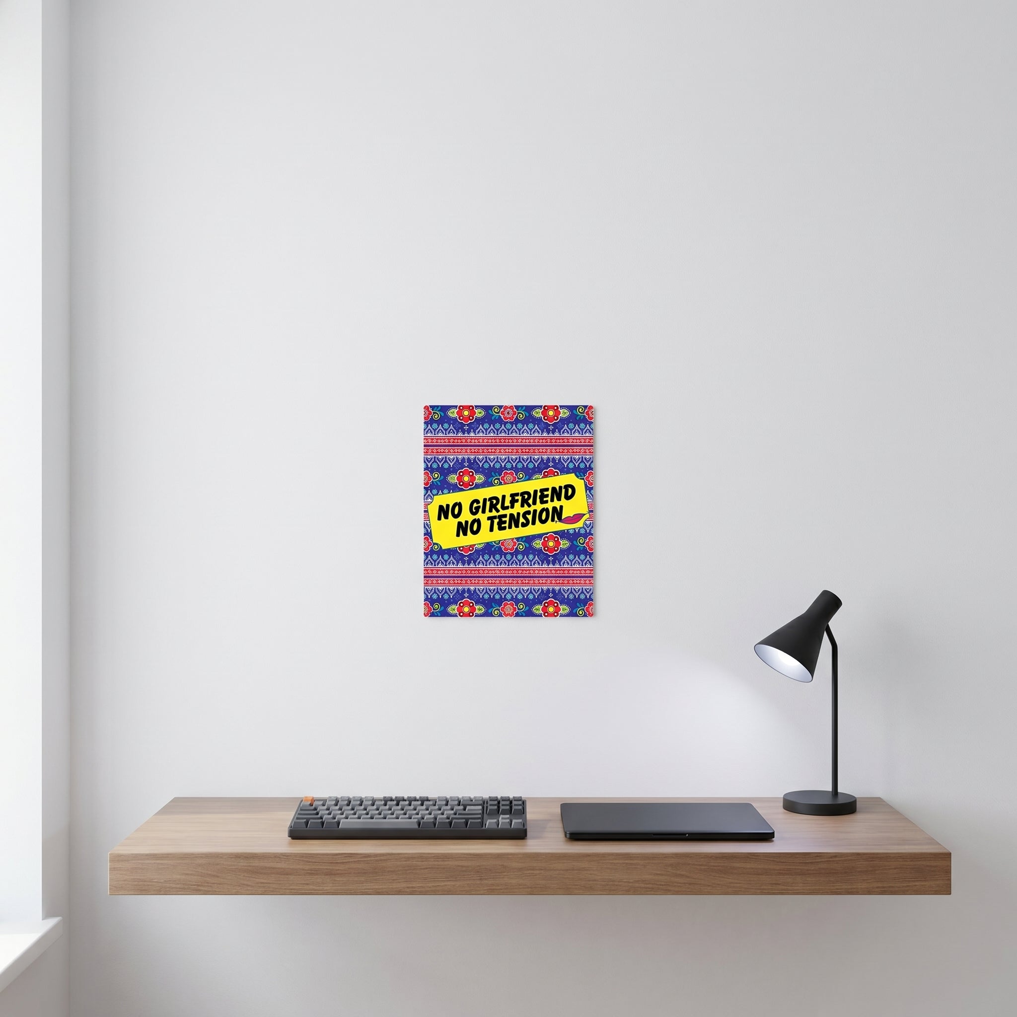 No Girlfriend No Tension aluminum art print displayed on a white wall behind a modern minimalist home office workspace setup.
