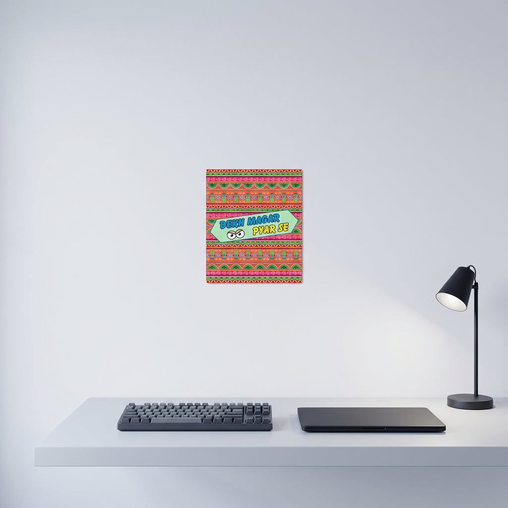 Traditional style South Asian poetry poster displayed on a crisp white wall behind a minimalist home office desk setup.
