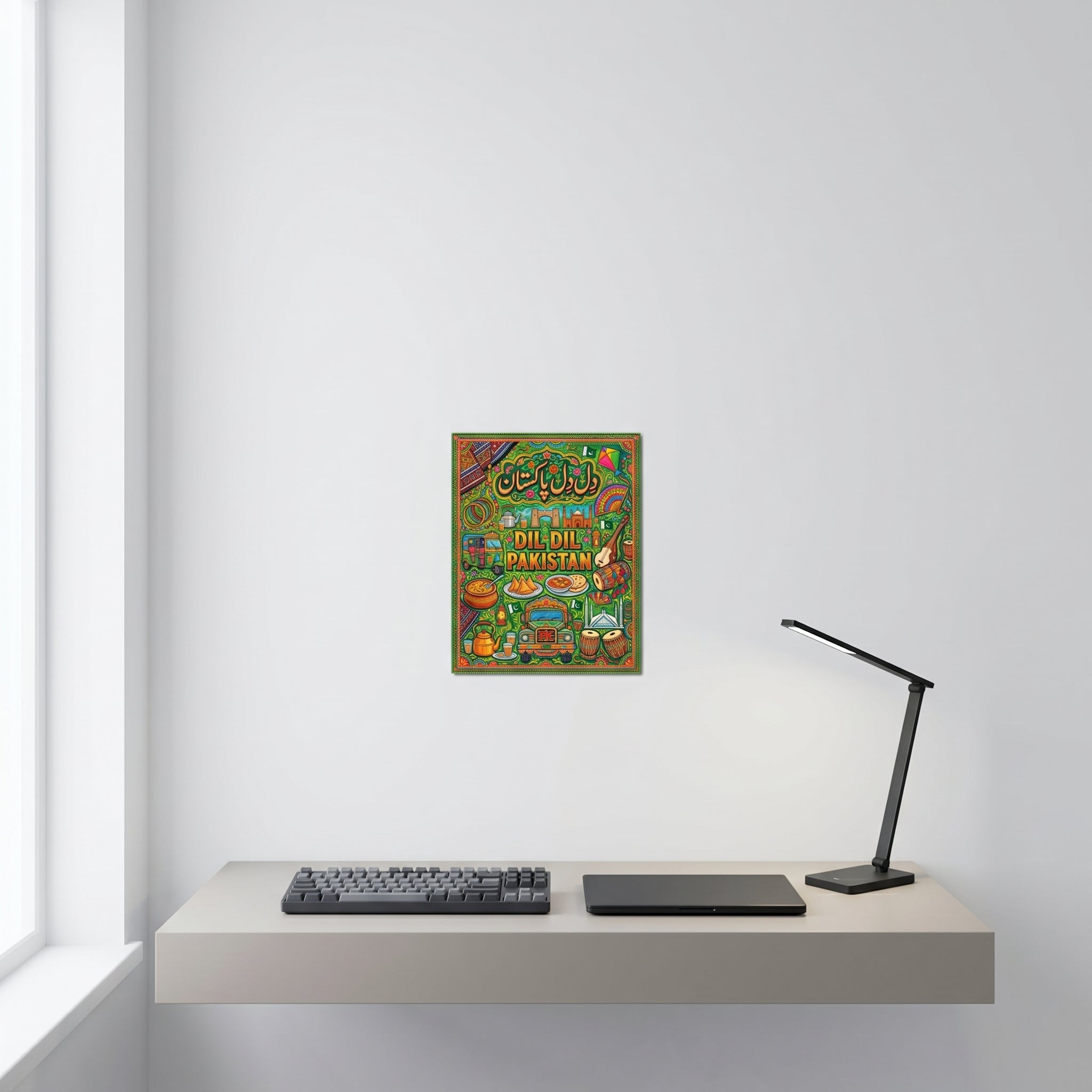 Traditional style Pakistani cultural heritage art print displayed on a crisp white wall behind a minimalist home office desk setup.