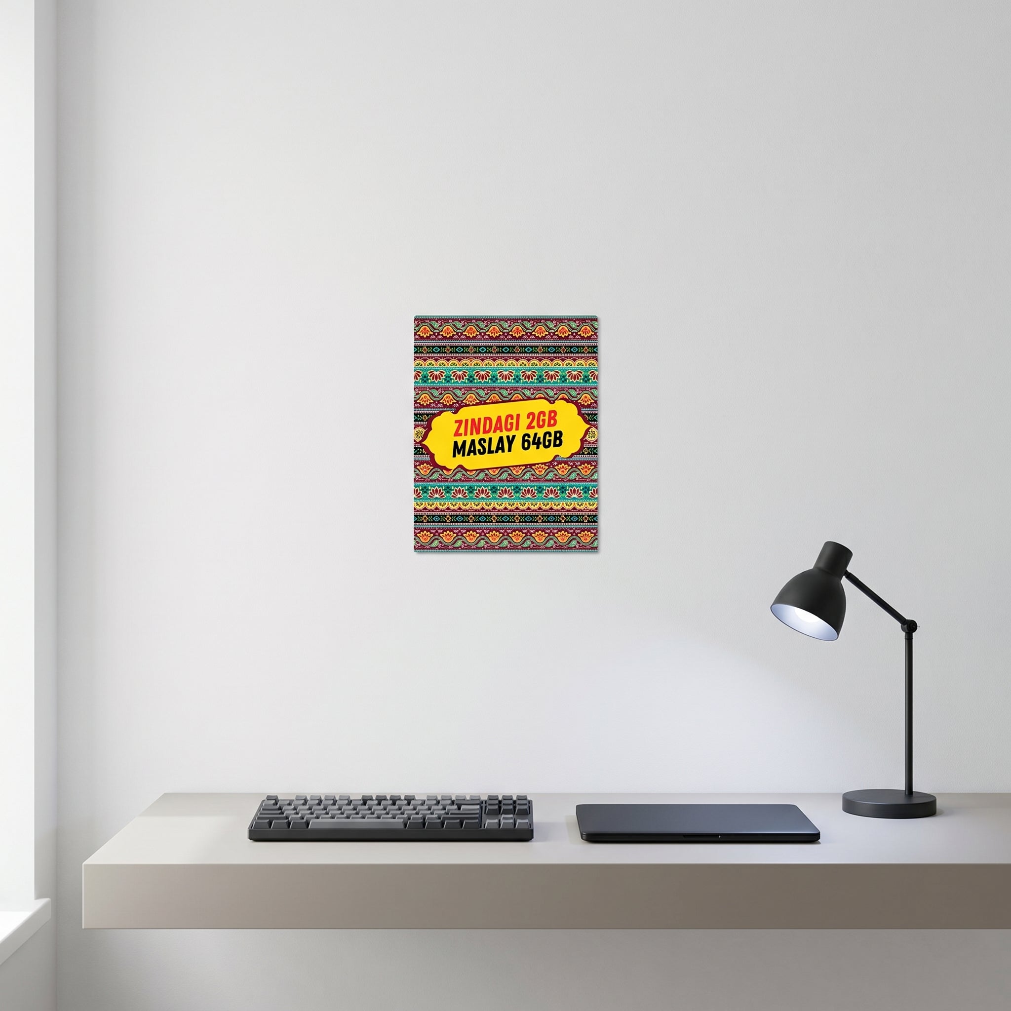 Traditional style South Asian internet culture poster displayed on a white wall behind a minimalist computer workspace setup.
