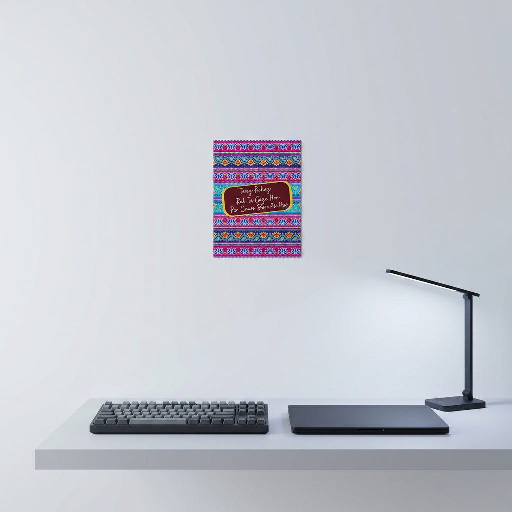 Vibrant Desi culture poster hanging elegantly on a white wall behind a minimalist home office desk setup with laptop.
