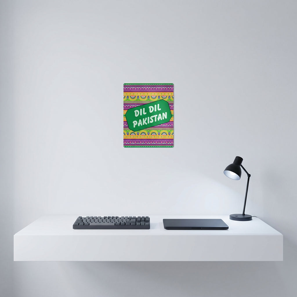 Vibrant Pakistani culture poster hanging elegantly on a crisp white wall behind a modern minimalist home office workspace setup.
