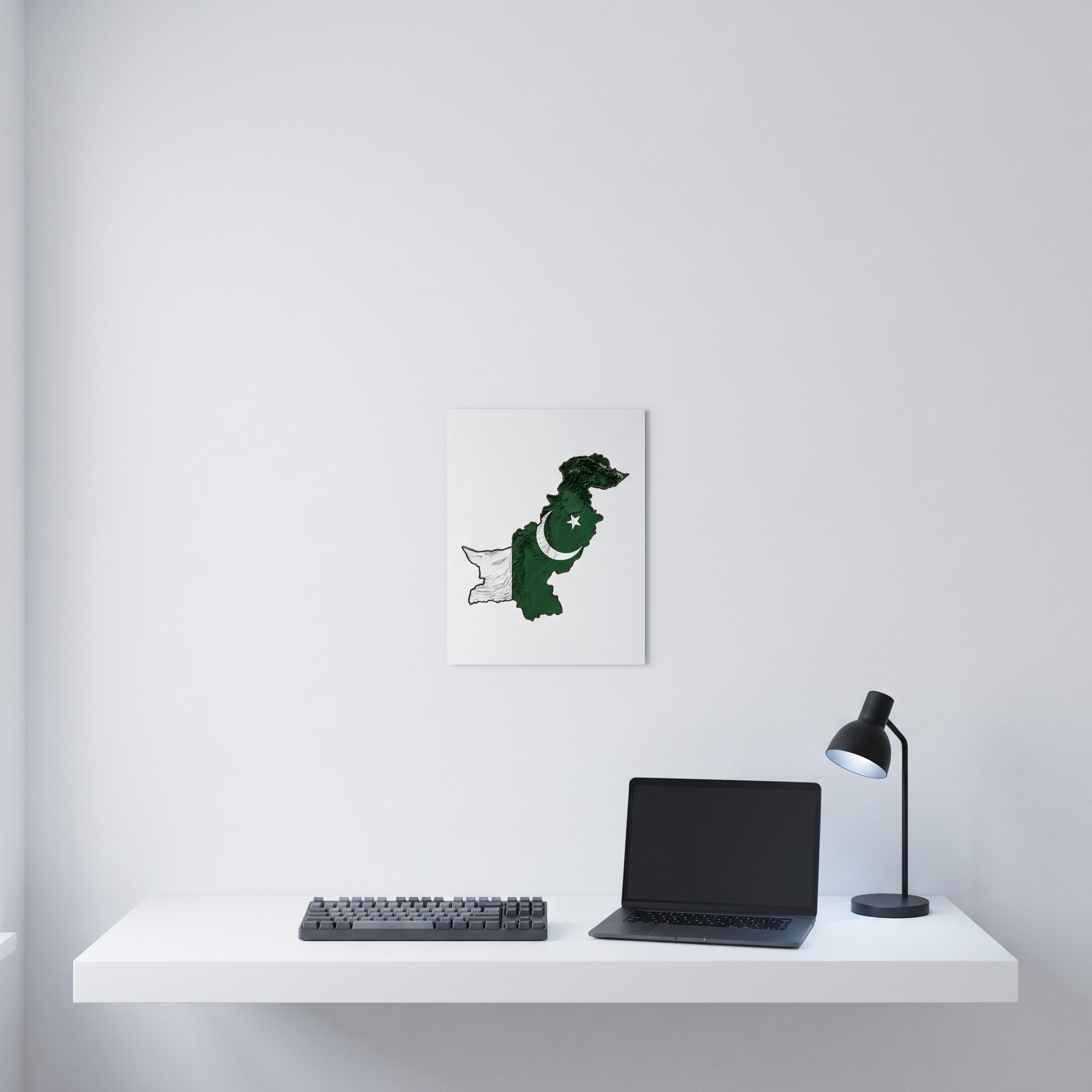 Vibrant Pakistani map statement sign styled on a crisp white wall behind a minimalist home office desk setup with a keyboard.