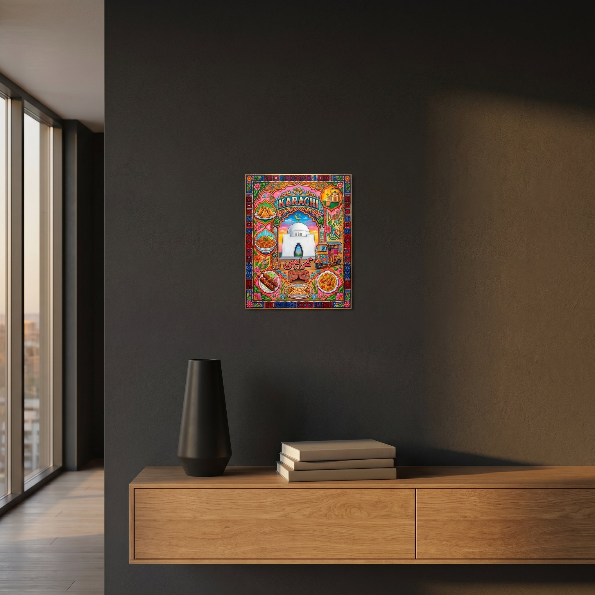Vibrant South Asian heritage room decor print catching warm light above a wooden nightstand in a moody dark-walled bedroom.
