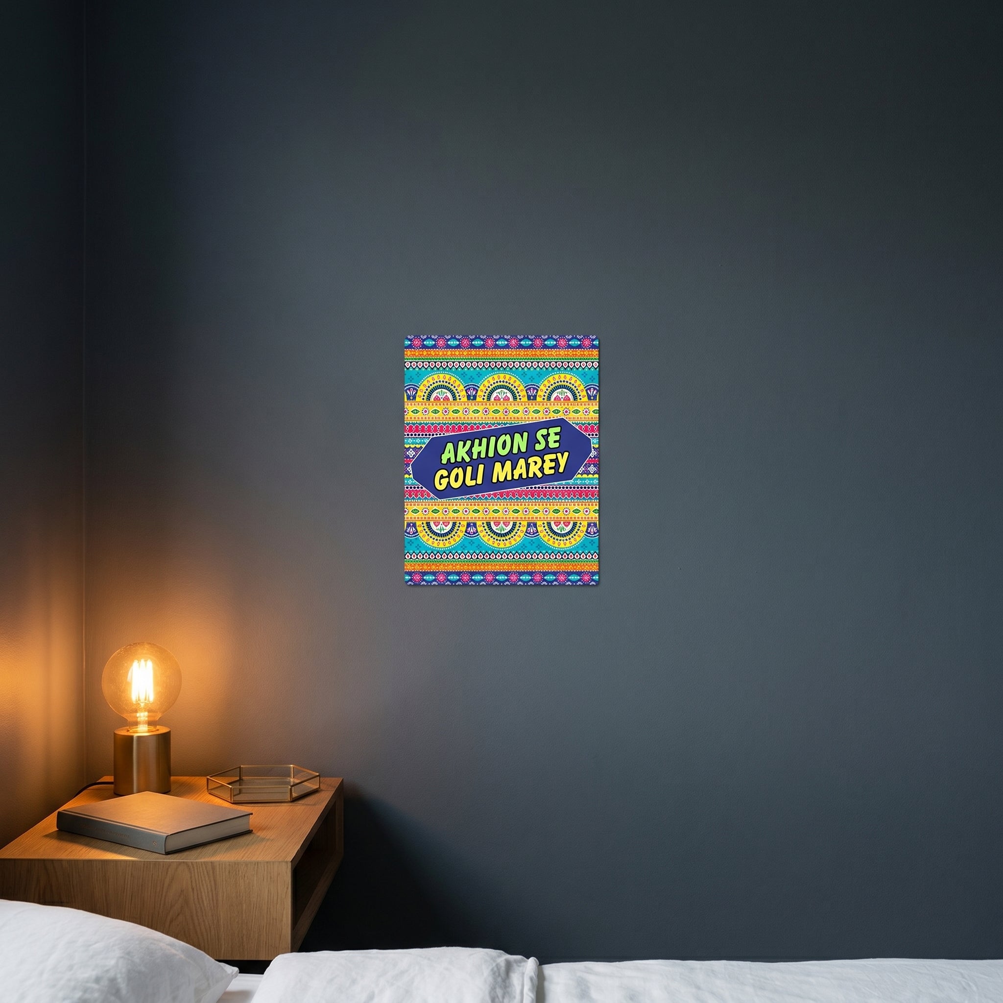 Humorous Urdu Hindi phrase metal sign catching warm ambient light from a lamp on a contemporary dark nightstand.
